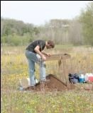 ANT field school with student sifting through soil